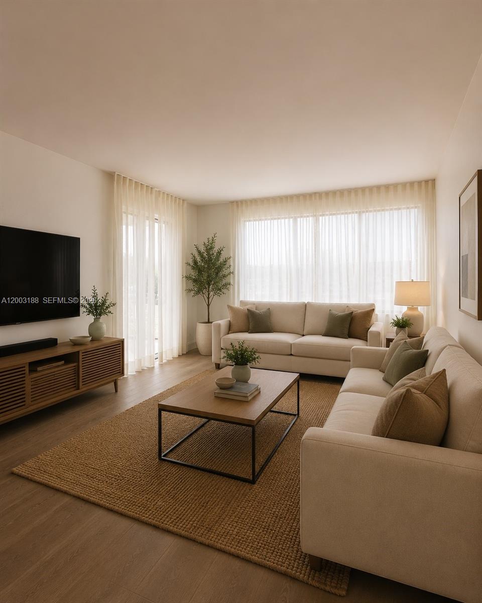 This living room features two beige sofas, a wooden coffee table, and floor-to-ceiling curtains — 2312 S Cypress Bend Dr # 107, Pompano Beach FL 33069, POMPANO BEACH, FL