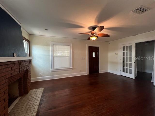 A living room features a brick fireplace, hardwood floors, a ceiling fan, and French doors — 4748 7TH AVENUE N, ST PETERSBURG, FL