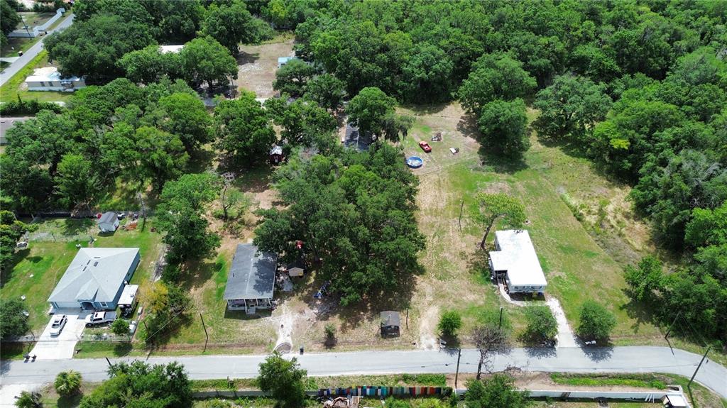An aerial view shows two houses on a large, wooded lot with a paved road — 2204 SHIRAH ROAD, AUBURNDALE, FL