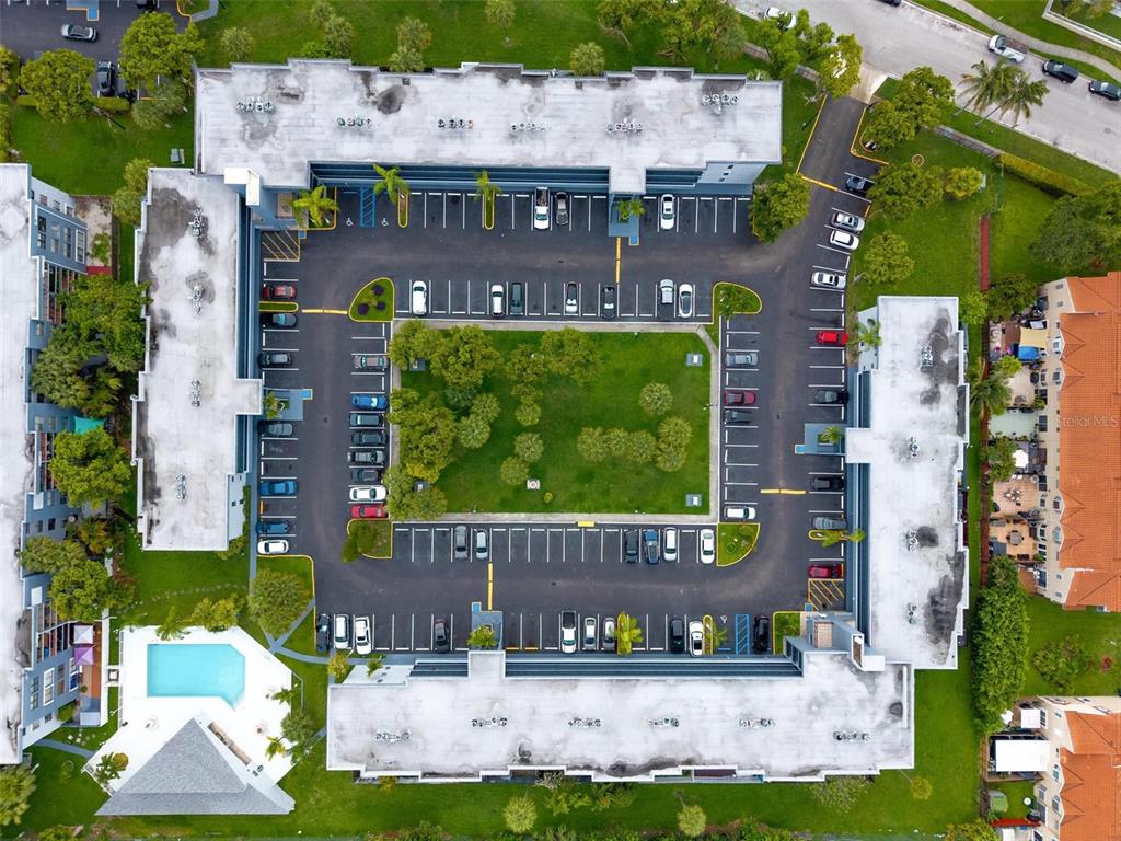 An aerial view shows a U-shaped apartment complex surrounding a central courtyard and parking lot — 13870 SW 62ND STREET UNIT 210, MIAMI, FL