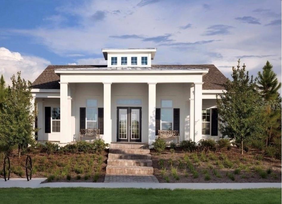 A white single-story house with a front porch, columns, and a central roof cupola — 15349 SHONAN GOLD DRIVE, WINTER GARDEN, FL