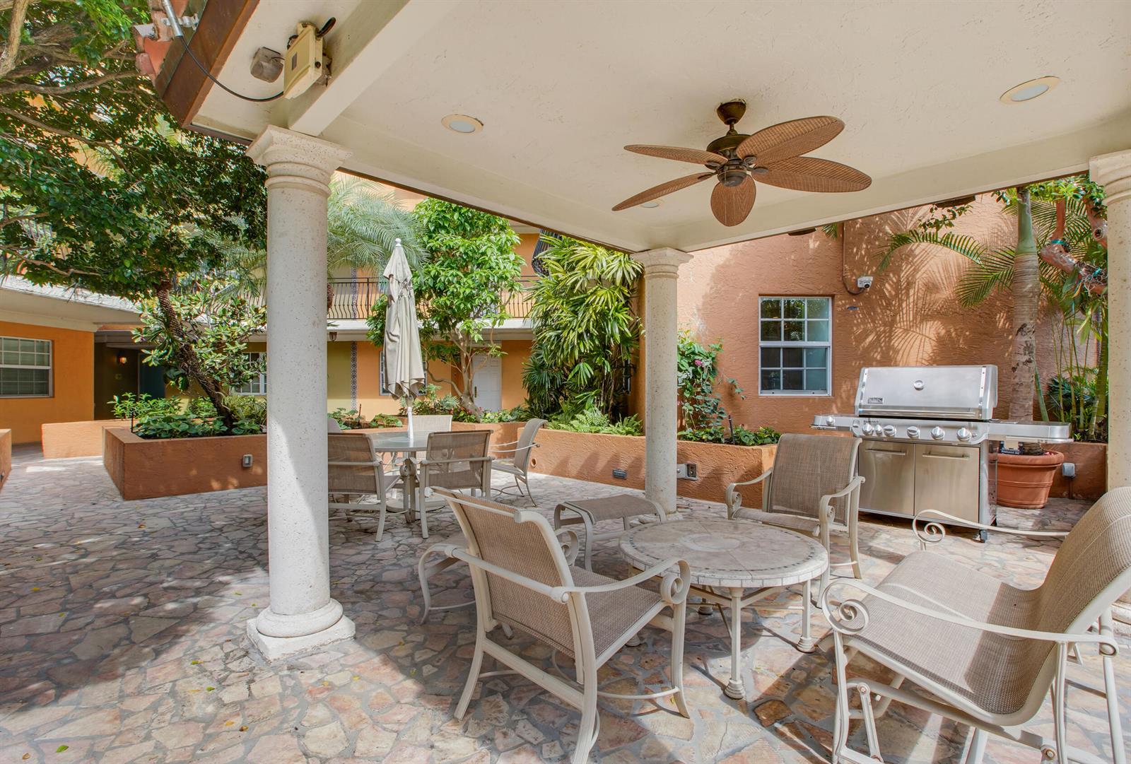 A covered outdoor patio features a stone floor, dining furniture, and a stainless steel grill — 1111 E Las Olas Boulevard # 410, Fort Lauderdale FL 33301, FORT LAUDERDALE, FL