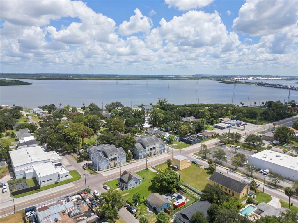 An aerial view shows a coastal town with houses, businesses, and a large body of water — 718 S 22ND STREET, TAMPA, FL