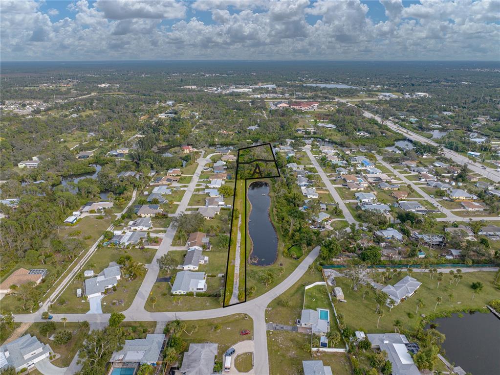 An aerial view shows a vacant lot marked with an A next to a pond — STRATFORD ROAD, ENGLEWOOD, FL