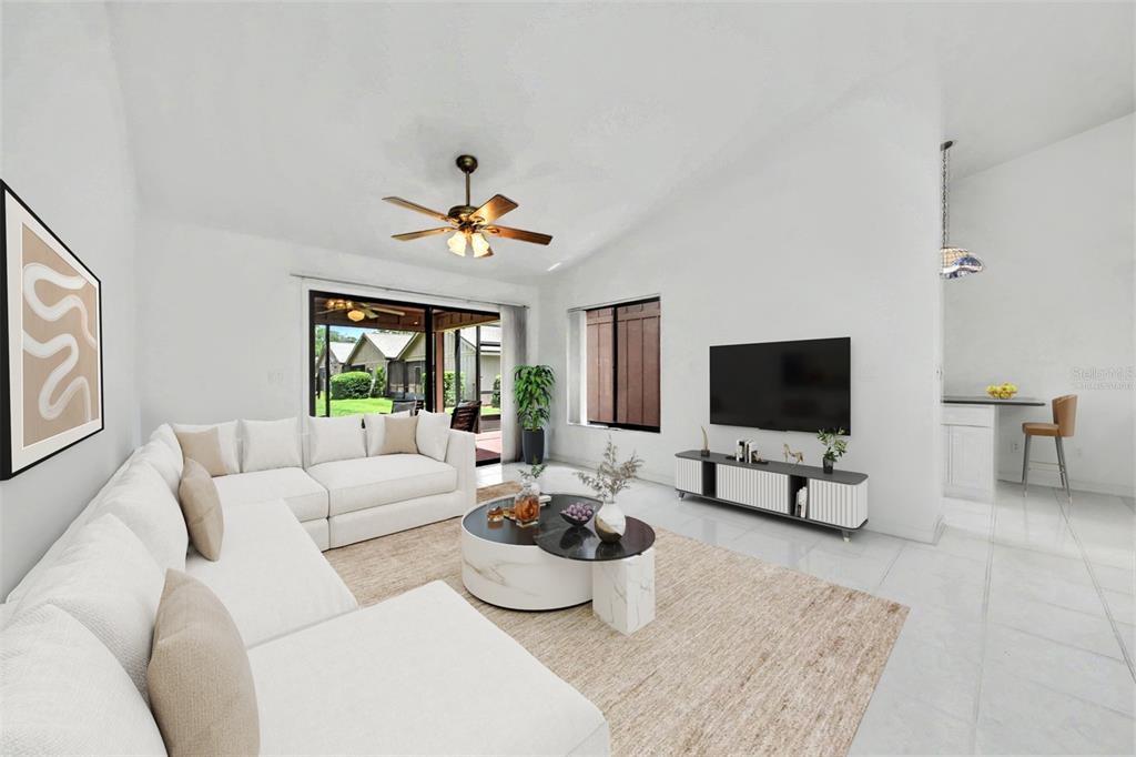 A bright living room features a white sectional sofa, a marble coffee table, and tile flooring — 1914 SPRUCEWOOD WAY, PORT ORANGE, FL