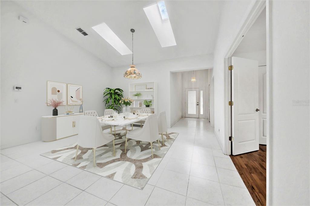 A bright dining room features white tile floors, a skylight, and a modern chandelier — 1914 SPRUCEWOOD WAY, PORT ORANGE, FL