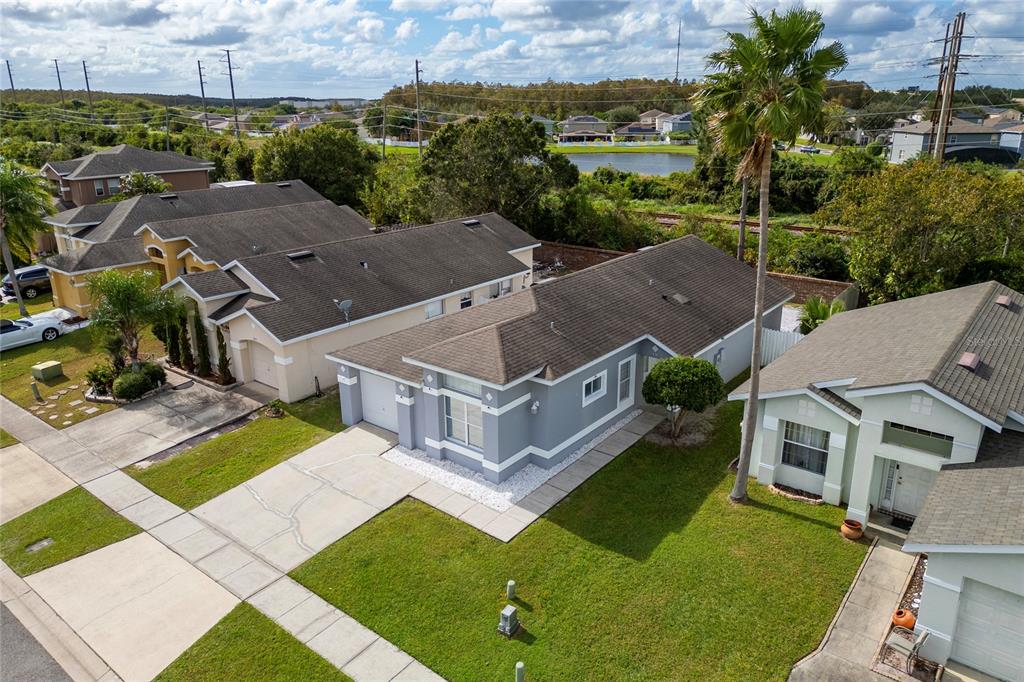 An aerial view shows several suburban houses with gray roofs and lawns in a neighborhood — 217 WOODBAY COURT, ORLANDO, FL