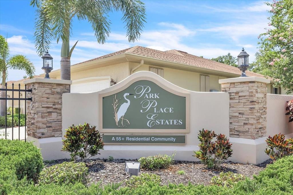 A stone-pillared monument sign marks the entrance to a 55+ residential community — 24057 PARK PLACE DRIVE S UNIT 51, PUNTA GORDA, FL
