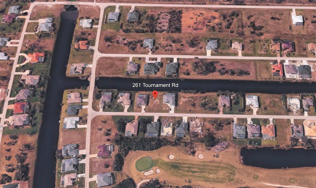 This aerial map shows a vacant residential lot situated along a canal and golf course — 261 TOURNAMENT ROAD, ROTONDA WEST, FL
