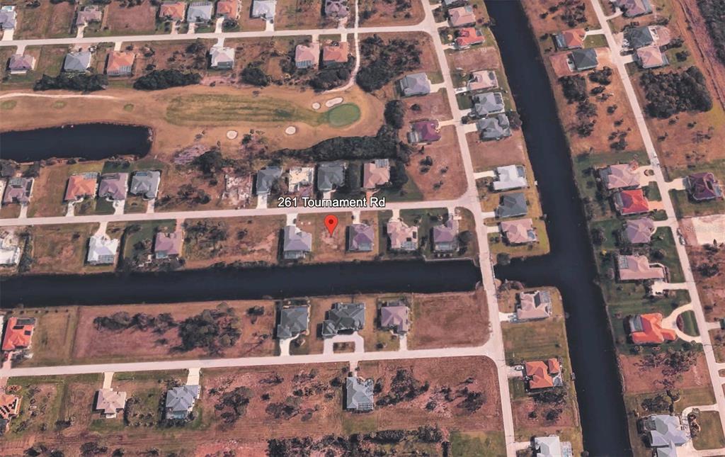 This aerial map view shows a residential neighborhood with houses, a canal, and a golf course — 261 TOURNAMENT ROAD, ROTONDA WEST, FL