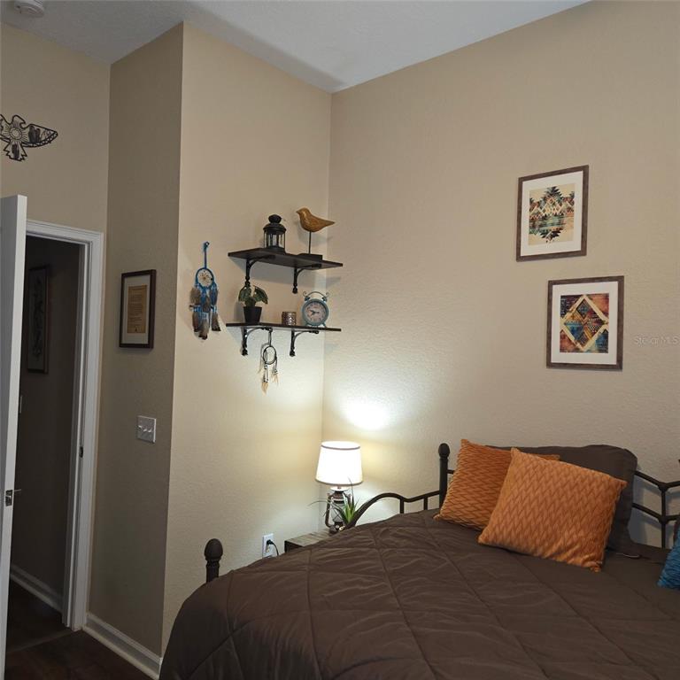 A single-story suburban house with a tan stucco exterior, a two-car garage, and a lawn — 3914 DERBY DRIVE, LAKELAND, FL