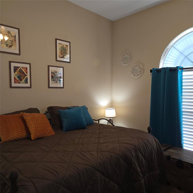 An entryway features double white doors, a wooden console table, and a patterned area rug — 3914 DERBY DRIVE, LAKELAND, FL
