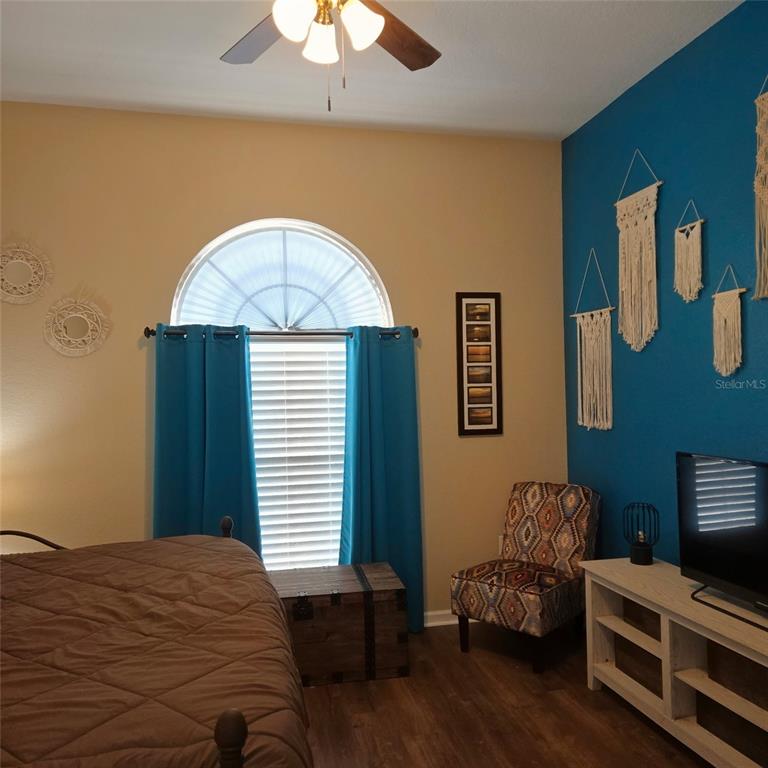 A home office with a desk and computer sits beside a living area with furniture — 3914 DERBY DRIVE, LAKELAND, FL