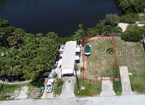An aerial view shows a waterfront lot with a mobile home and a boat parked nearby — 6981 EDGEWATER DRIVE, NEW PORT RICHEY, FL