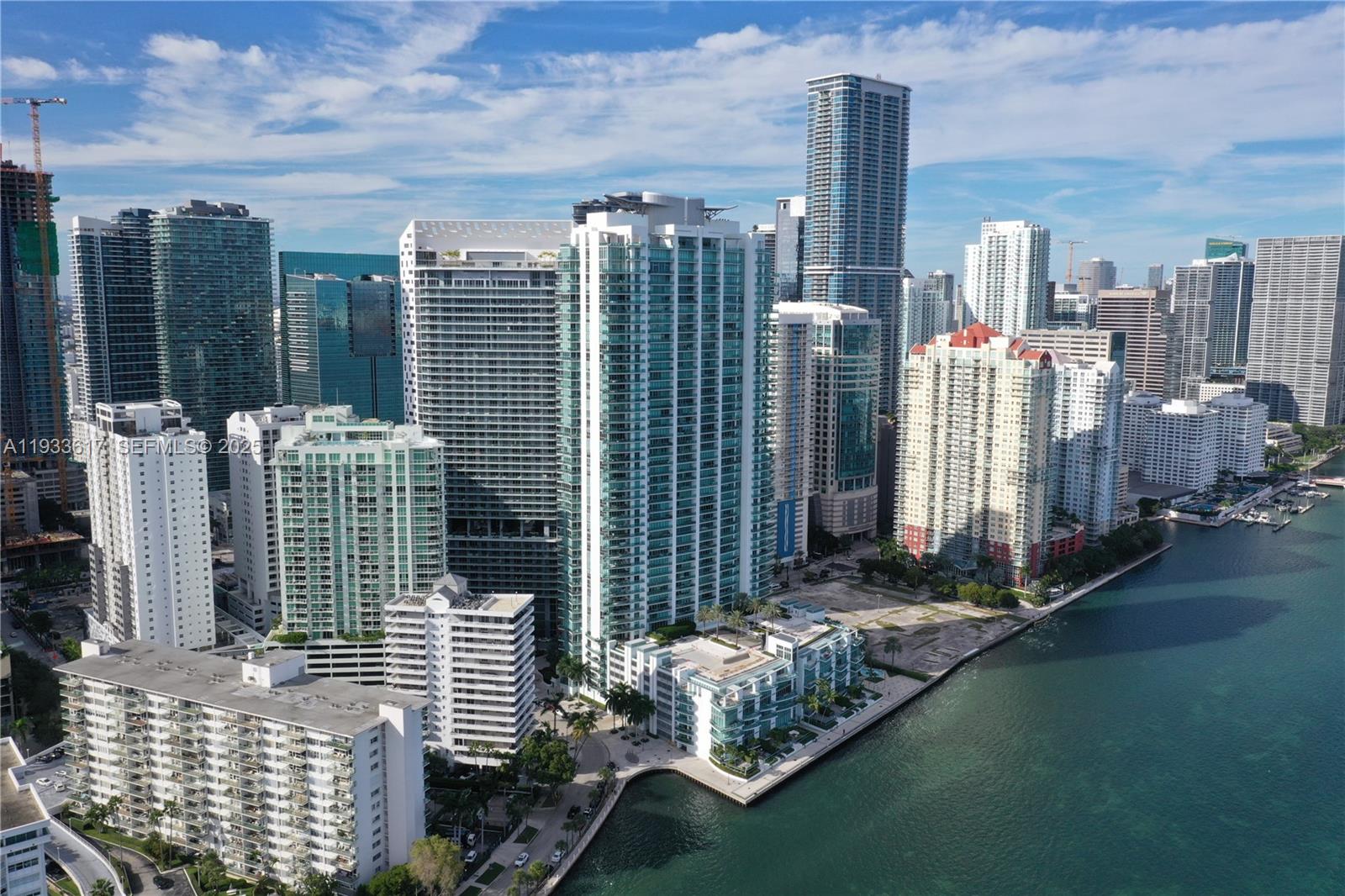 An aerial view of a dense urban skyline featuring numerous high-rise glass apartment buildings — 1331 Brickell Bay Dr # 1609, Miami FL 33131, MIAMI, FL