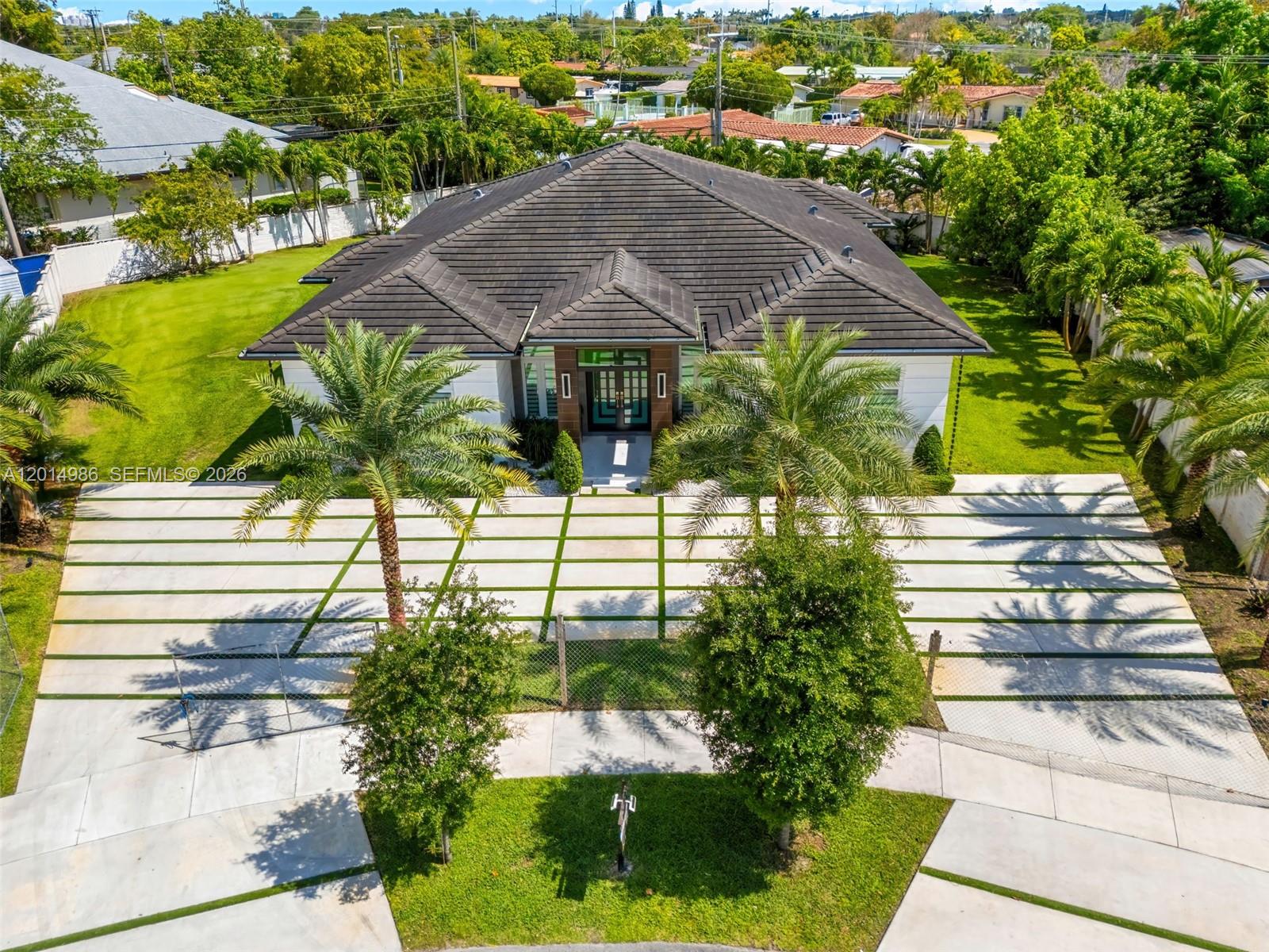 An aerial view shows a house with a tiled roof, palm trees, and a grid-patterned driveway — 5815 SW 107th Pl, Miami FL 33173, MIAMI, FL