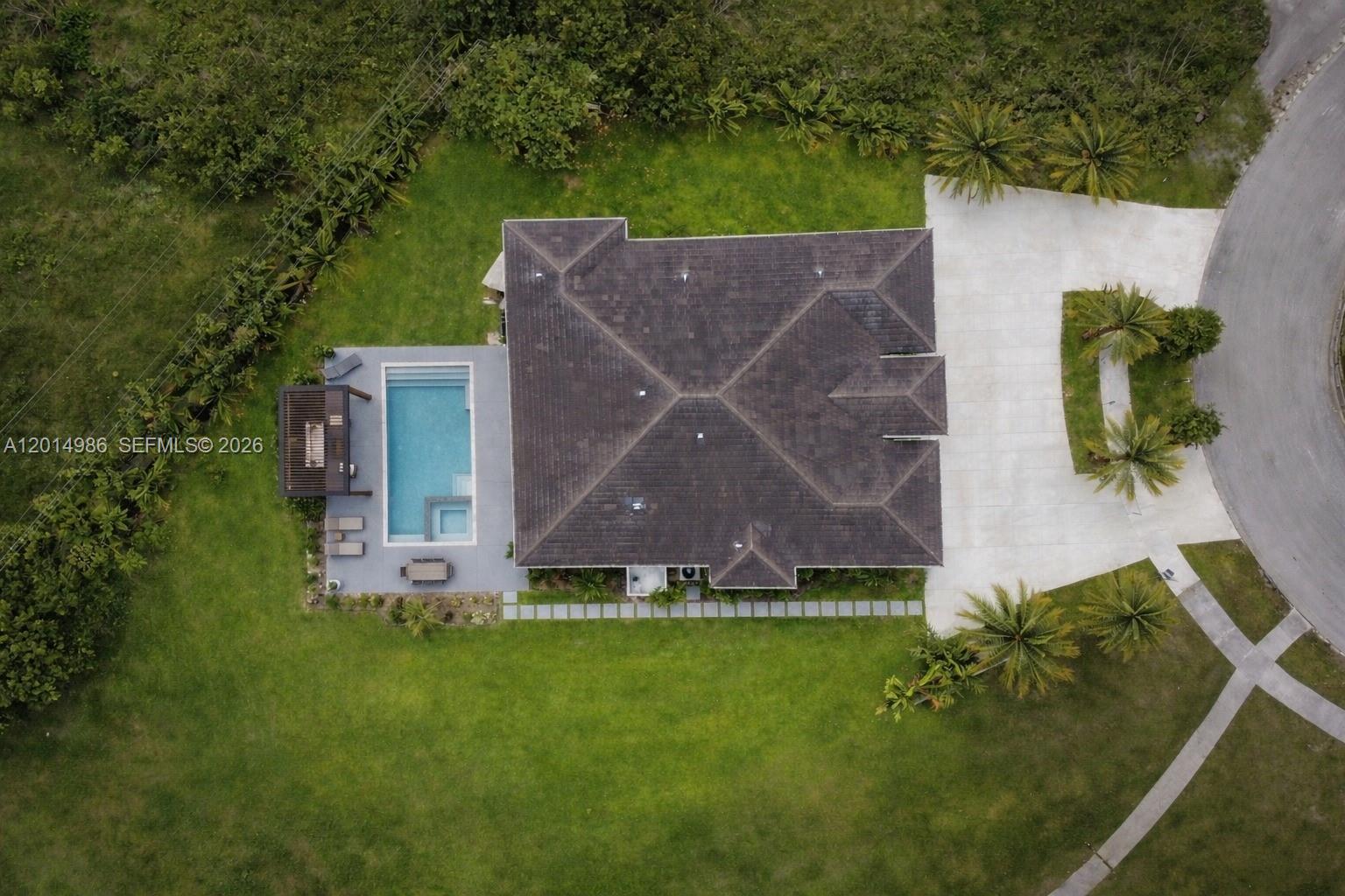 An aerial view shows a house with a dark roof, a swimming pool, and a driveway — 5815 SW 107th Pl, Miami FL 33173, MIAMI, FL