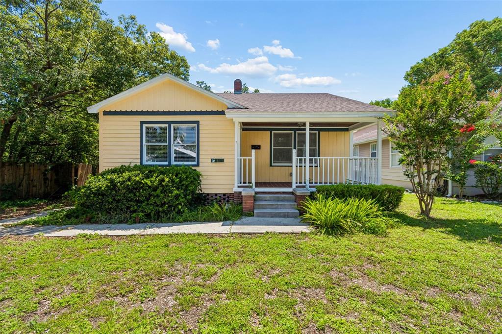 A yellow, single-story house with a front porch and a small yard — 1019 S TENNESSEE AVENUE, LAKELAND, FL
