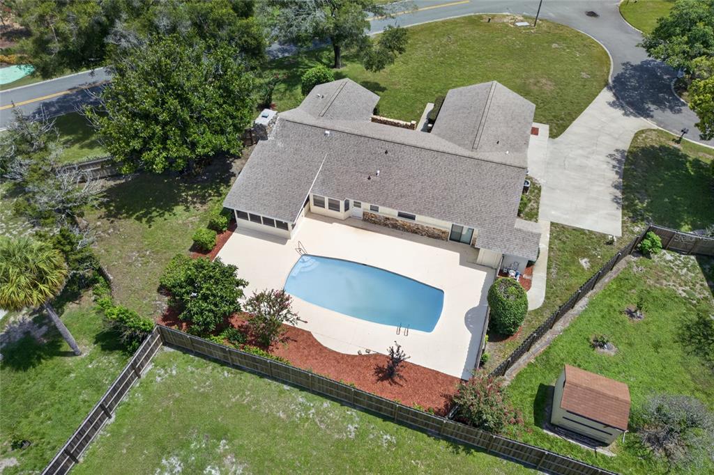 An aerial view of a house with a swimming pool, patio, and fenced backyard — 2704 BURGOYNE PLACE, DELAND, FL