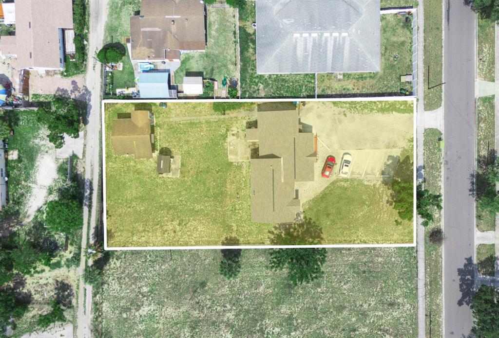 An aerial view shows a residential lot with a house, detached structure, and two cars — 1021 COHASSETT AVENUE, LAKE WALES, FL