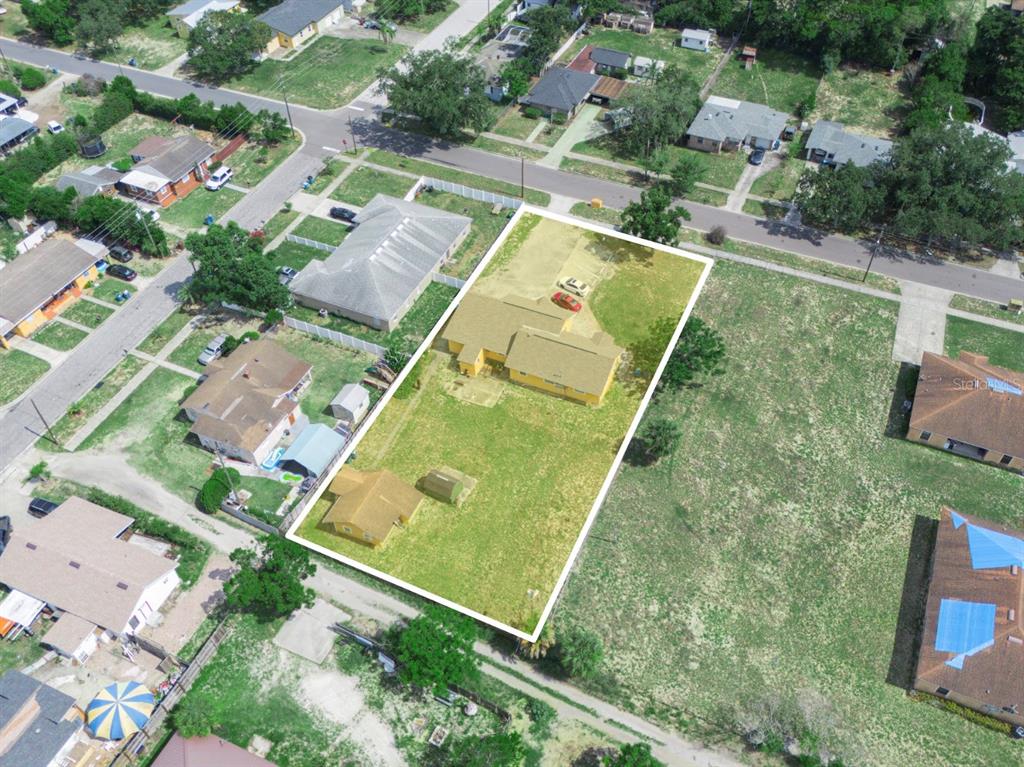 Aerial view of a residential property with two buildings on a large grassy lot — 1021 COHASSETT AVENUE, LAKE WALES, FL