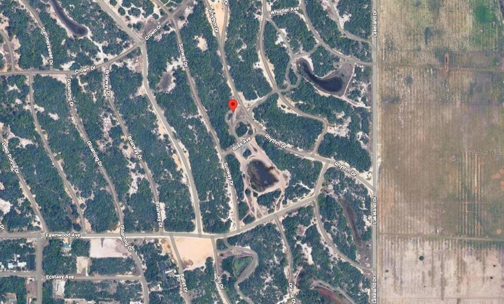 This is an aerial map showing a residential neighborhood with winding streets and wooded lots — 232 RHYTHM DRIVE, LAKE PLACID, FL