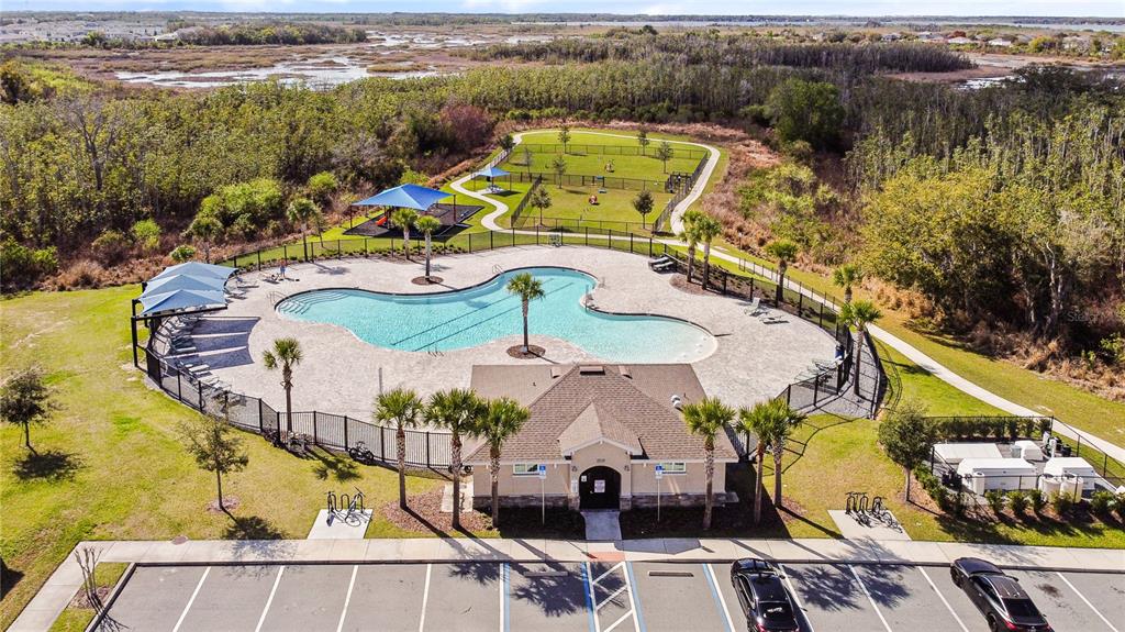 An aerial view shows a community swimming pool, a fenced dog park, and a parking lot — 4847 RIGGING ST, HAINES CITY, FL