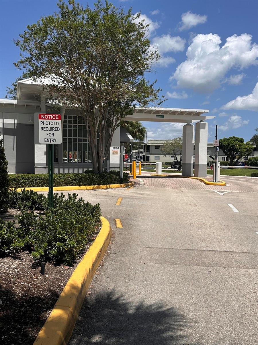 A gated entrance features a security booth with a photo ID requirement sign — 750 Burgundy P, Delray Beach FL 33484, DELRAY BEACH, FL