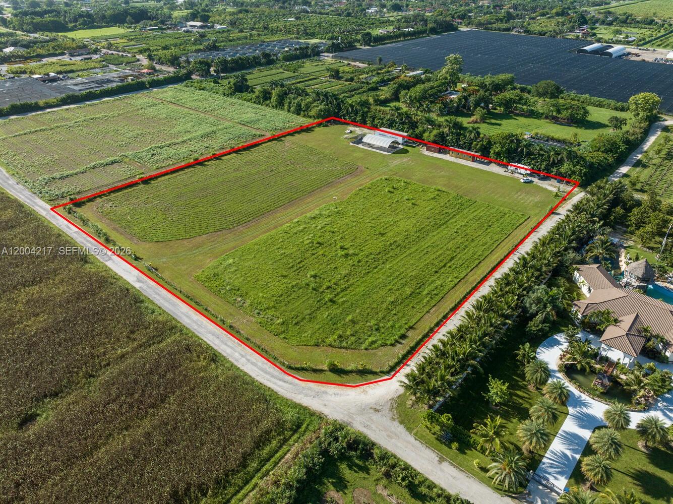 An aerial view shows a large, rectangular plot of land outlined in red — 21750 SW 226 terrace, FL 33170, FL
