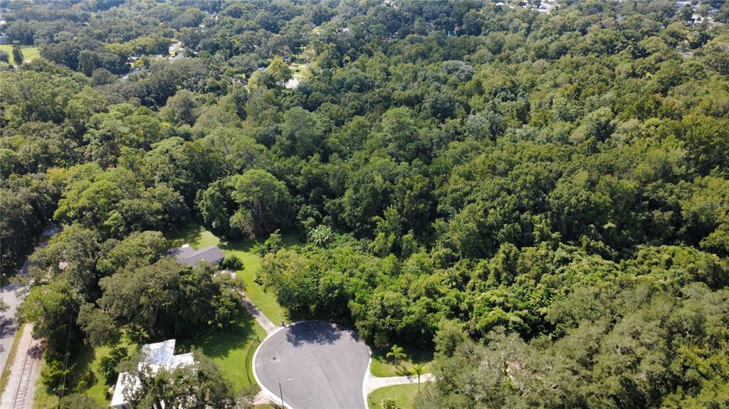 An aerial view shows a cul-de-sac surrounded by a dense forest and residential properties — 2016 GRANDVIEW AVENUE N, SANFORD, FL