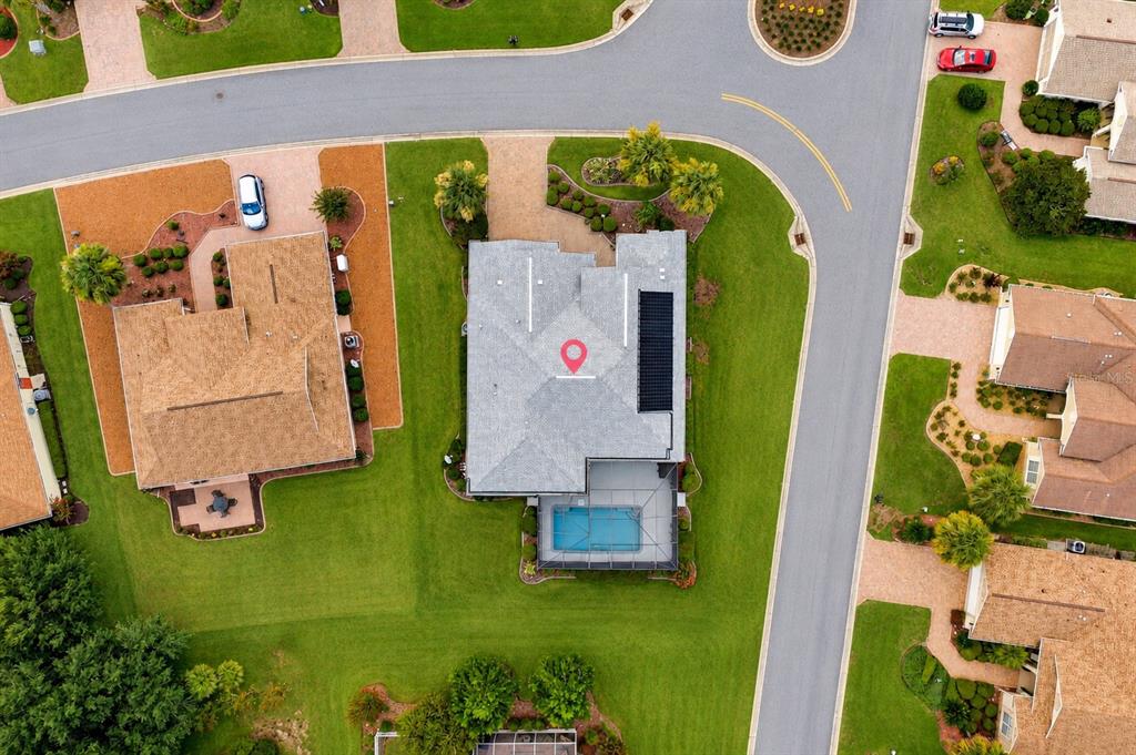 An aerial view shows a house with a pool and solar panels on a suburban street — 8616 SW 82ND TERRACE, OCALA, FL