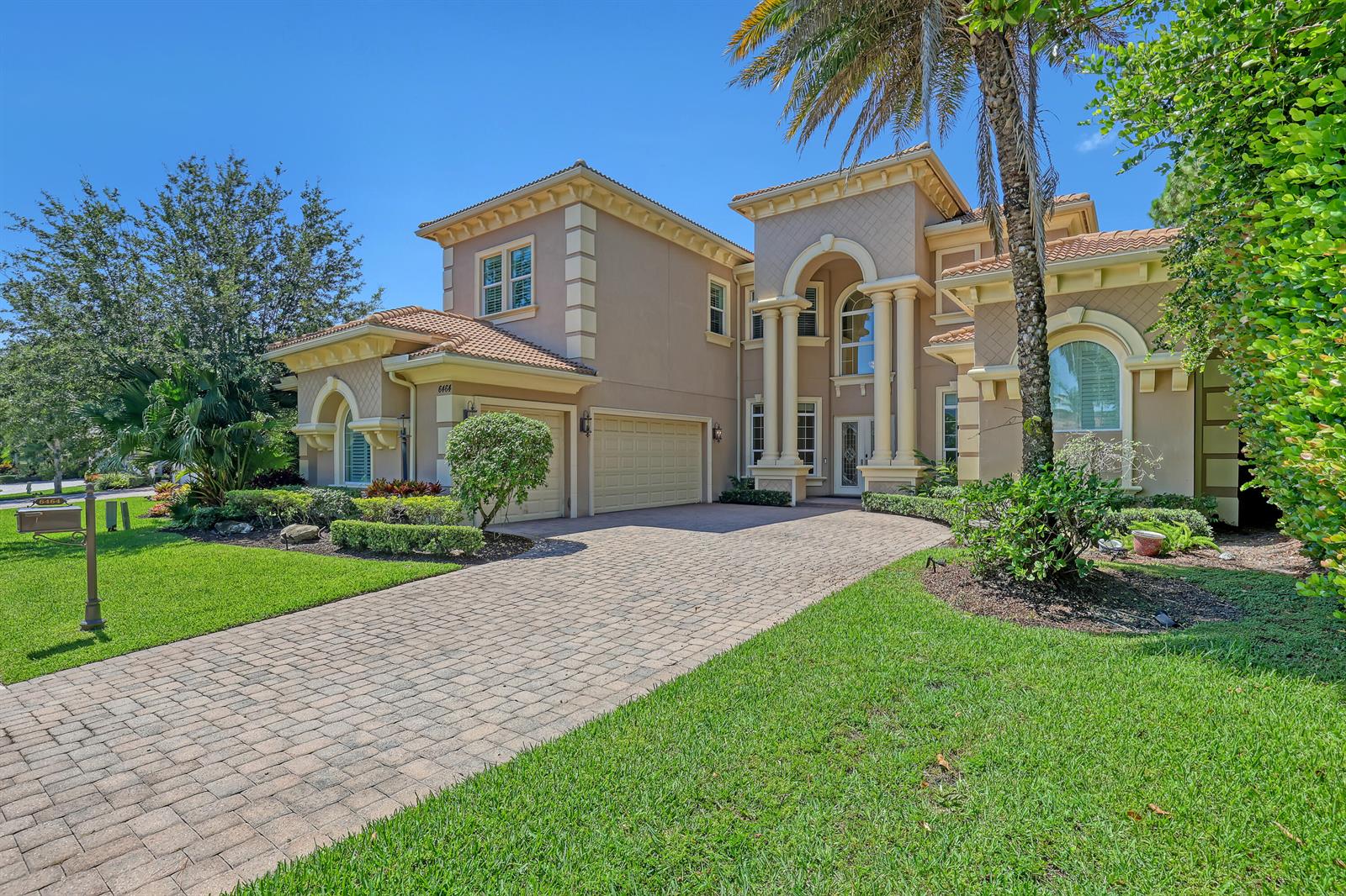 A two-story stucco house with a tiled roof, arched entryway, and a paved driveway — 6464 Bellamalfi Street, Boca Raton FL 33496, BOCA RATON, FL