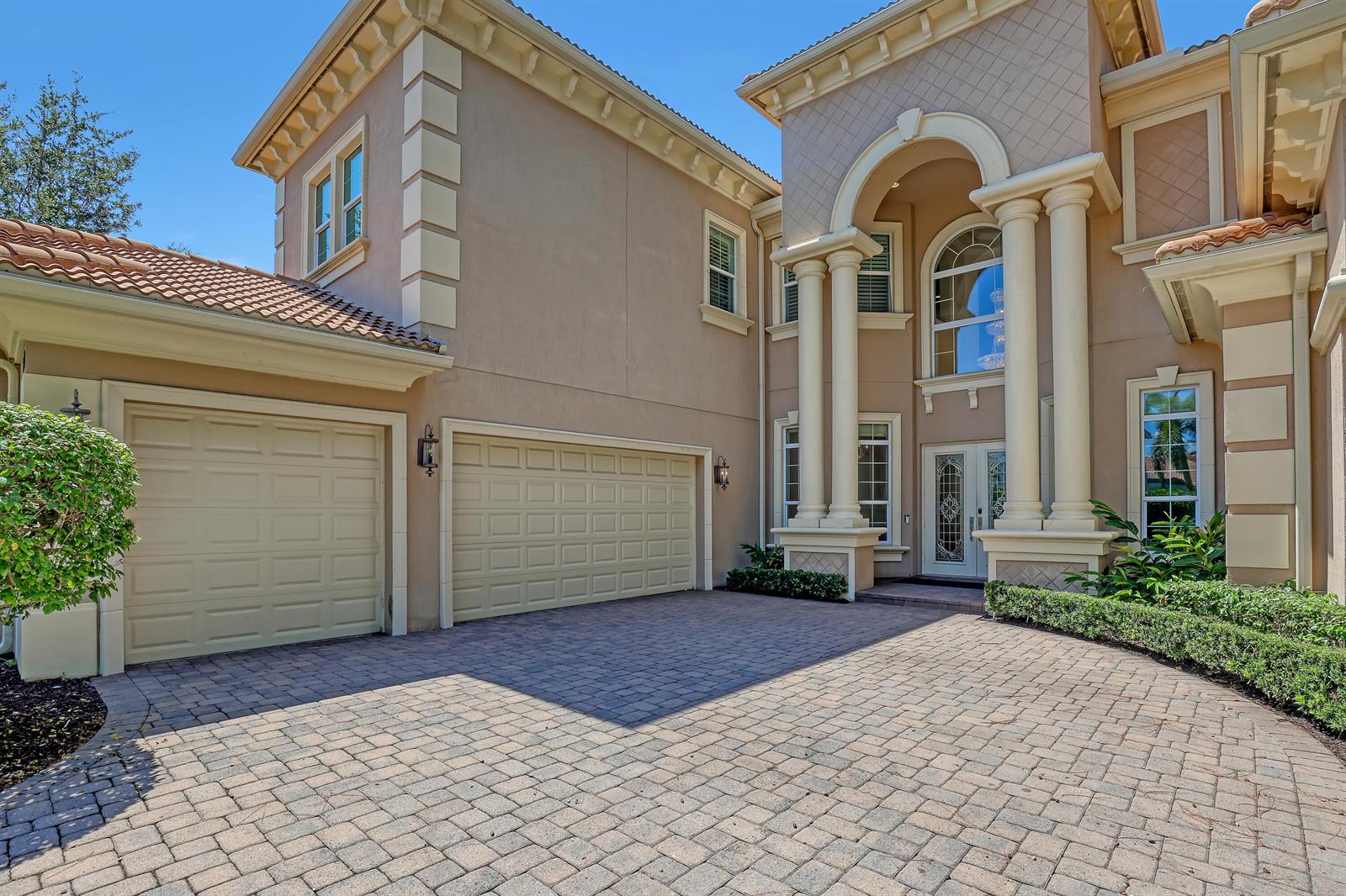 A two-story stucco house features a three-car garage and a paved driveway — 6464 Bellamalfi Street, Boca Raton FL 33496, BOCA RATON, FL