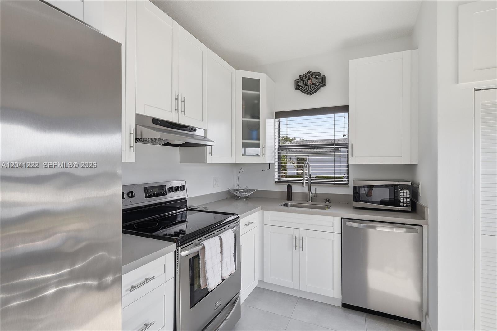 A kitchen features white cabinets, stainless steel appliances, and gray countertops — 6443 SW 152nd Cir Pl # 43, Miami FL 33193, MIAMI, FL