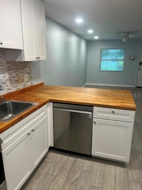 A room features a large wooden table in the foreground and white floor-to-ceiling cabinets — 2808 W AZEELE UNIT 103, TAMPA, FL
