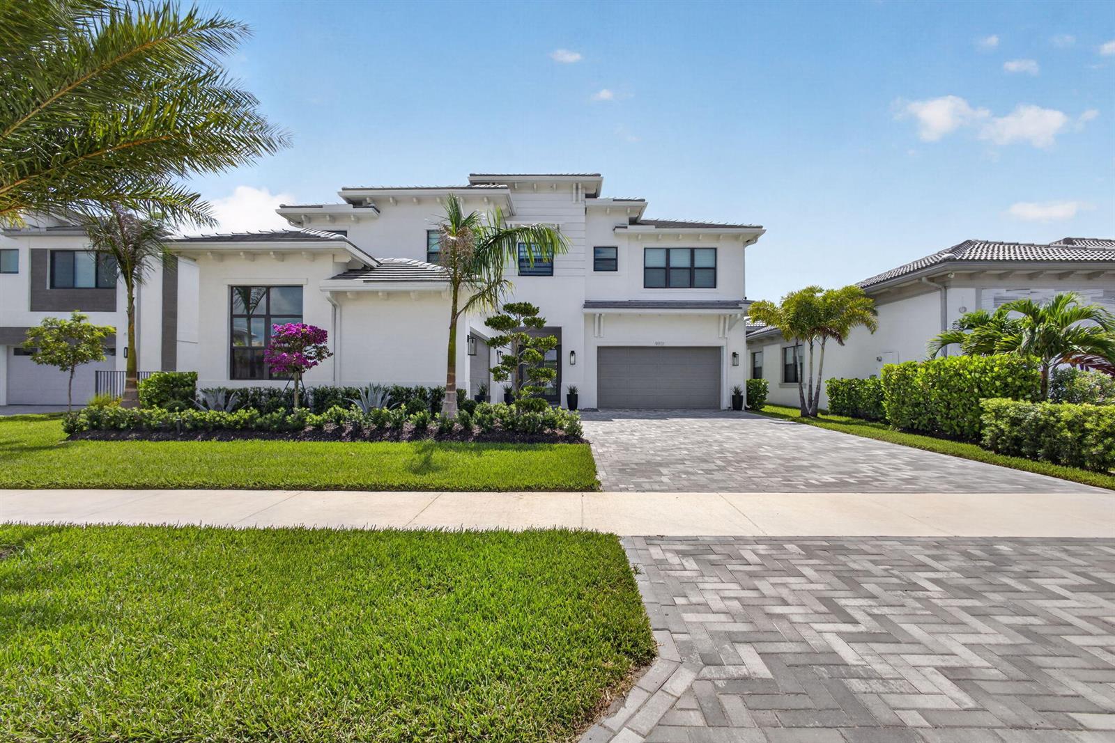 A two-story white house with a gray garage and a paved driveway — 9931 Migration Point, Palm Beach Gardens FL 33412, PALM BEACH GARDENS, FL