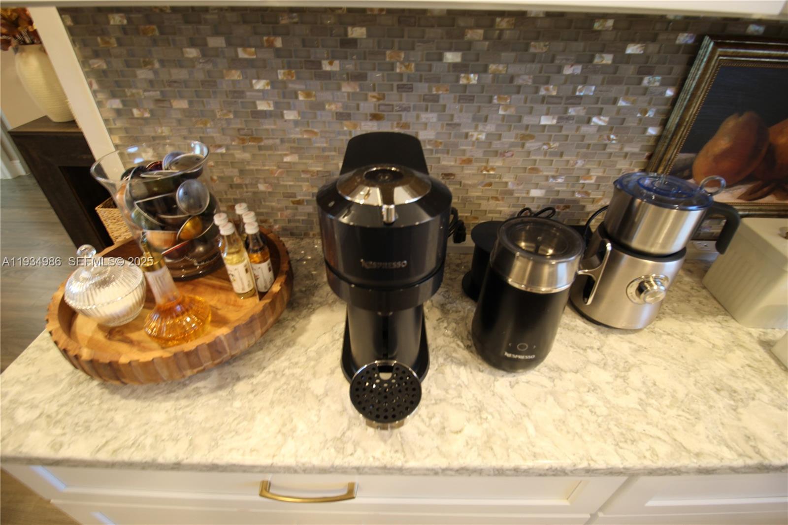 A kitchen counter features a Nespresso coffee machine, milk frothers, and a wooden serving tray — 7370 S Ocean Dr # 715, Jensen Beach FL 34957, JENSEN BEACH, FL