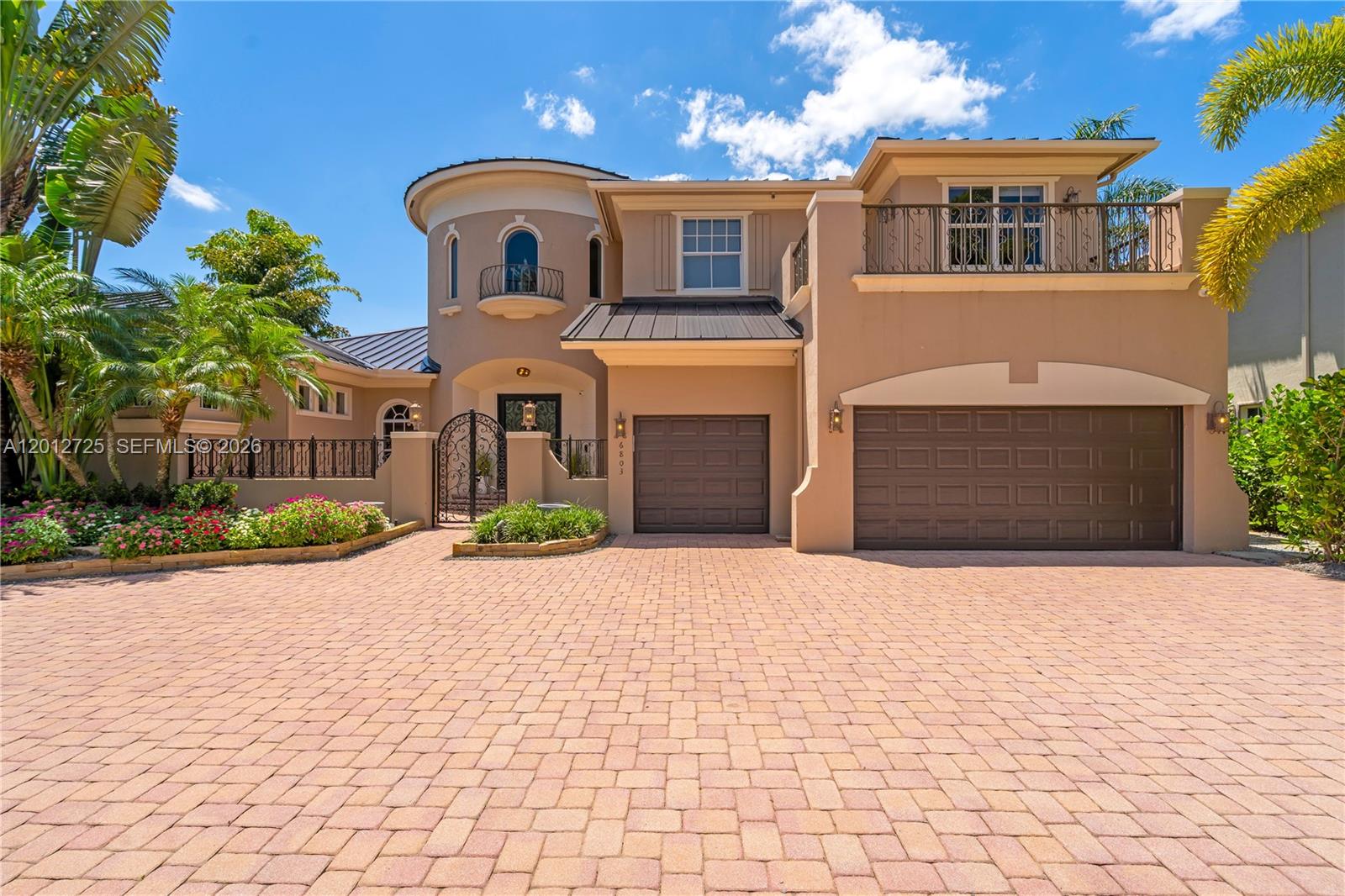 A two-story house with a circular tower, a paved driveway, and a three-car garage — 6803 NW 116th Ave, Parkland FL 33076, PARKLAND, FL
