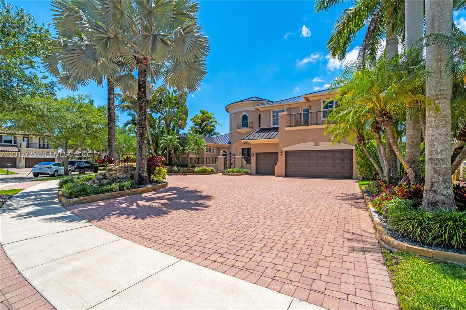 A two-story house with a paved driveway, a three-car garage, and palm trees — 6803 NW 116th Ave, Parkland FL 33076, PARKLAND, FL