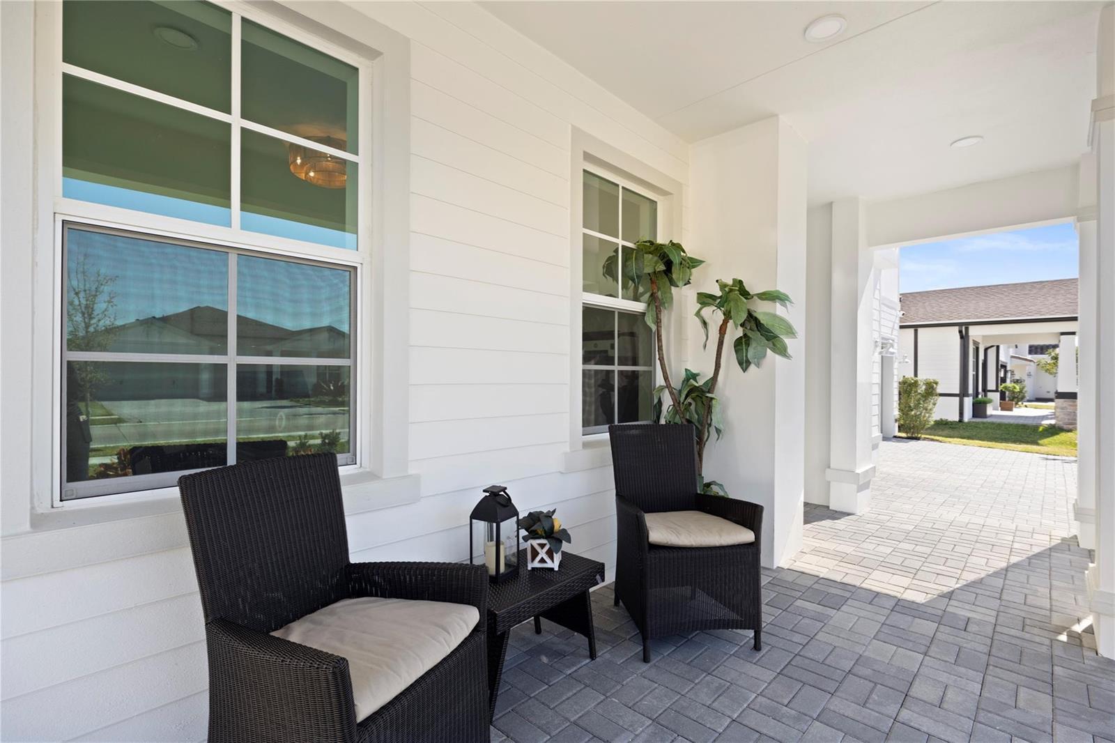 A modern kitchen features white cabinets, stainless steel appliances, a quartz island, and wood flooring — 1148 Tangled Orchard Trace, Loxahatchee FL 33470, LOXAHATCHEE, FL