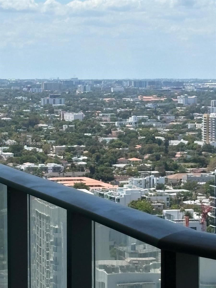 An elevated view of a suburban landscape with buildings and trees seen from a balcony — 1300 S Miami Ave # 2911, Miami FL 33130, MIAMI, FL