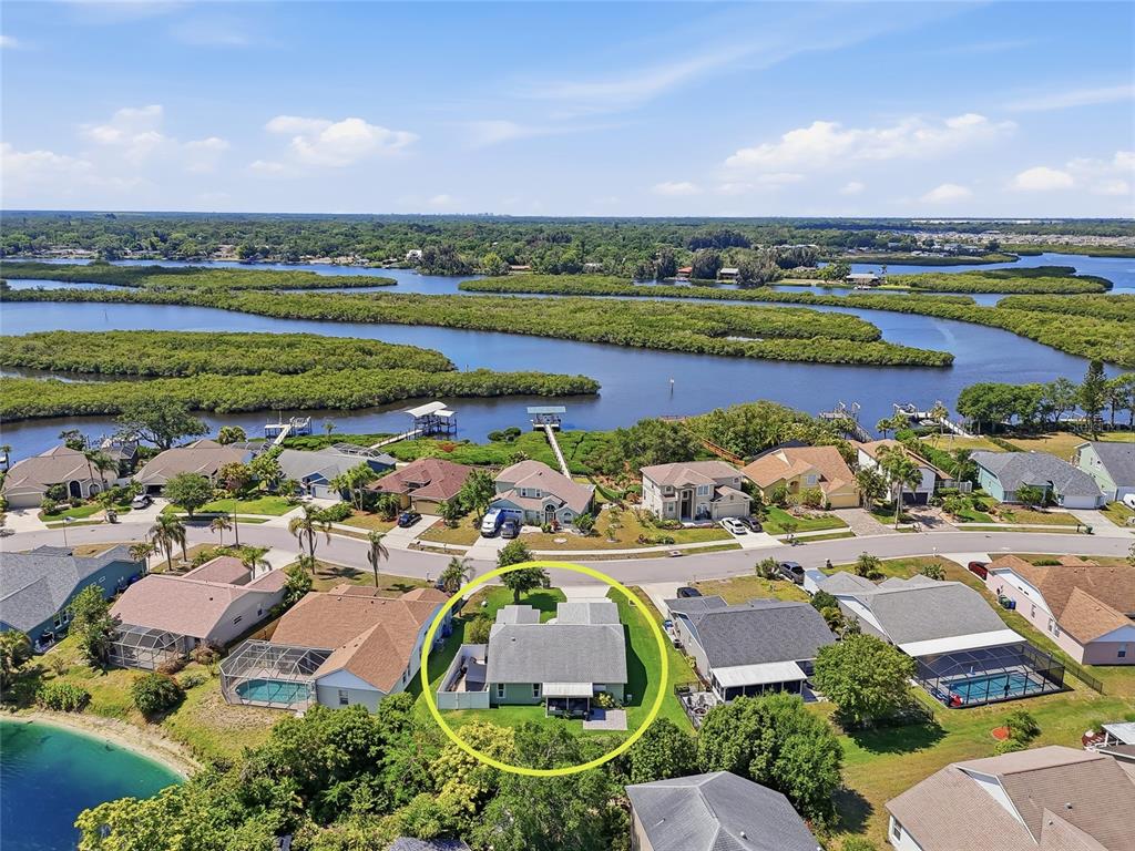 An aerial view shows a residential house with a gray roof circled in yellow — 4839 14TH AVENUE E, BRADENTON, FL