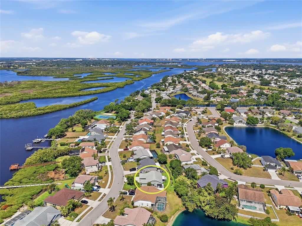 An aerial view shows a residential neighborhood with a highlighted house near a waterfront — 4839 14TH AVENUE E, BRADENTON, FL
