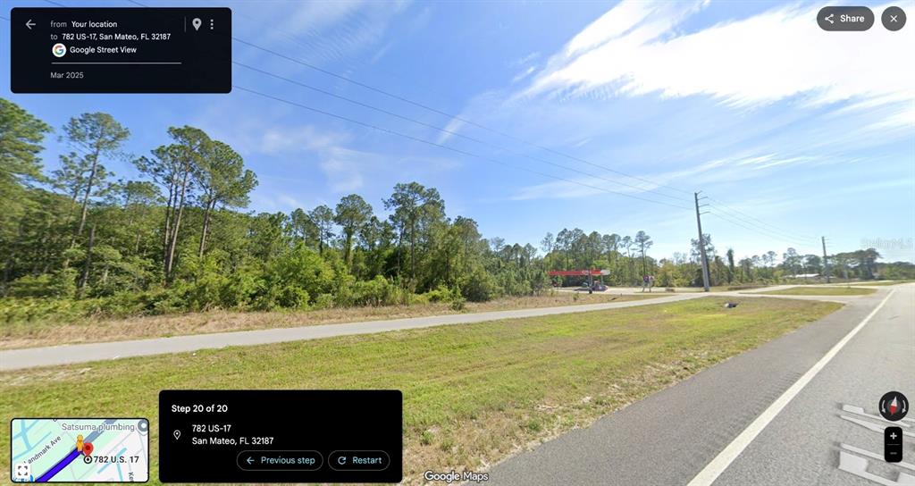 This is a Google Street View image showing a vacant, grassy lot with trees — 782 S US HIGHWAY 17, SAN MATEO, FL