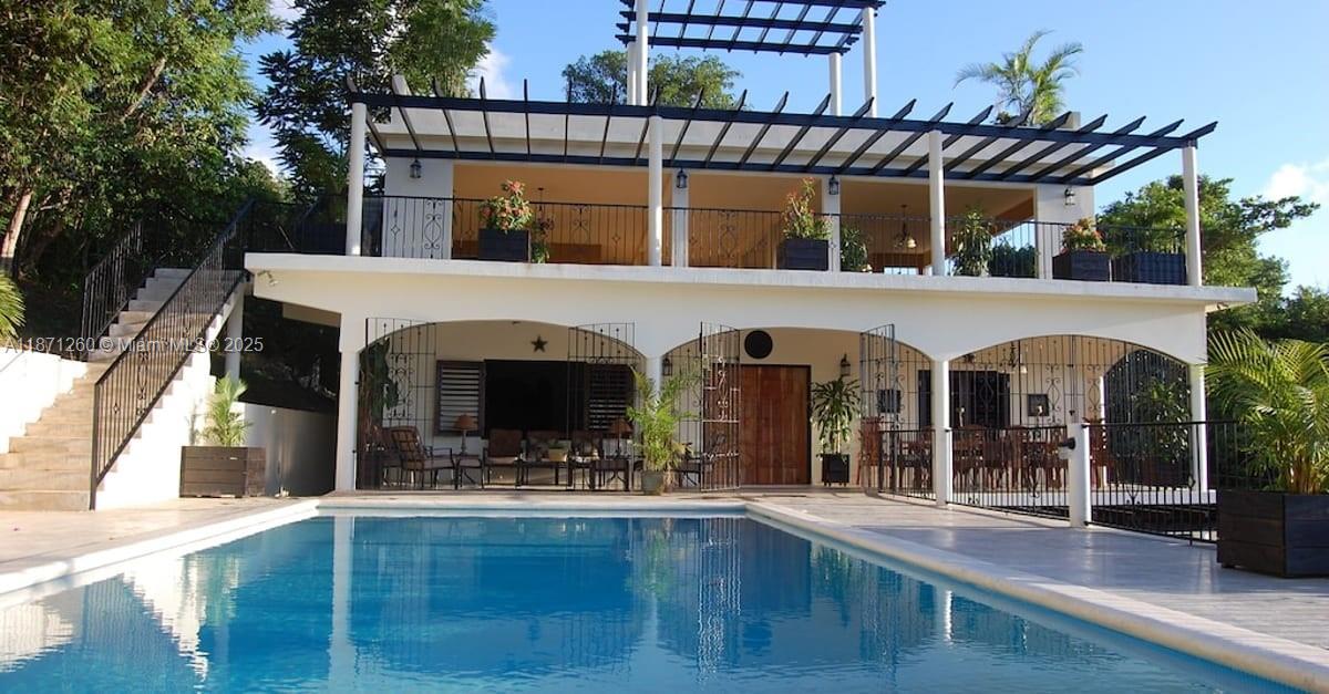 A two-story house with a swimming pool, a large upper balcony, and a pergola roof — 20 RM Cardiff Hall Villa St Ann, Jamaica, NA, NA