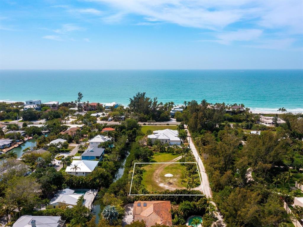 An aerial view shows a vacant rectangular lot near a beach and residential homes — 6604 GULF OF MEXICO DRIVE, LONGBOAT KEY, FL