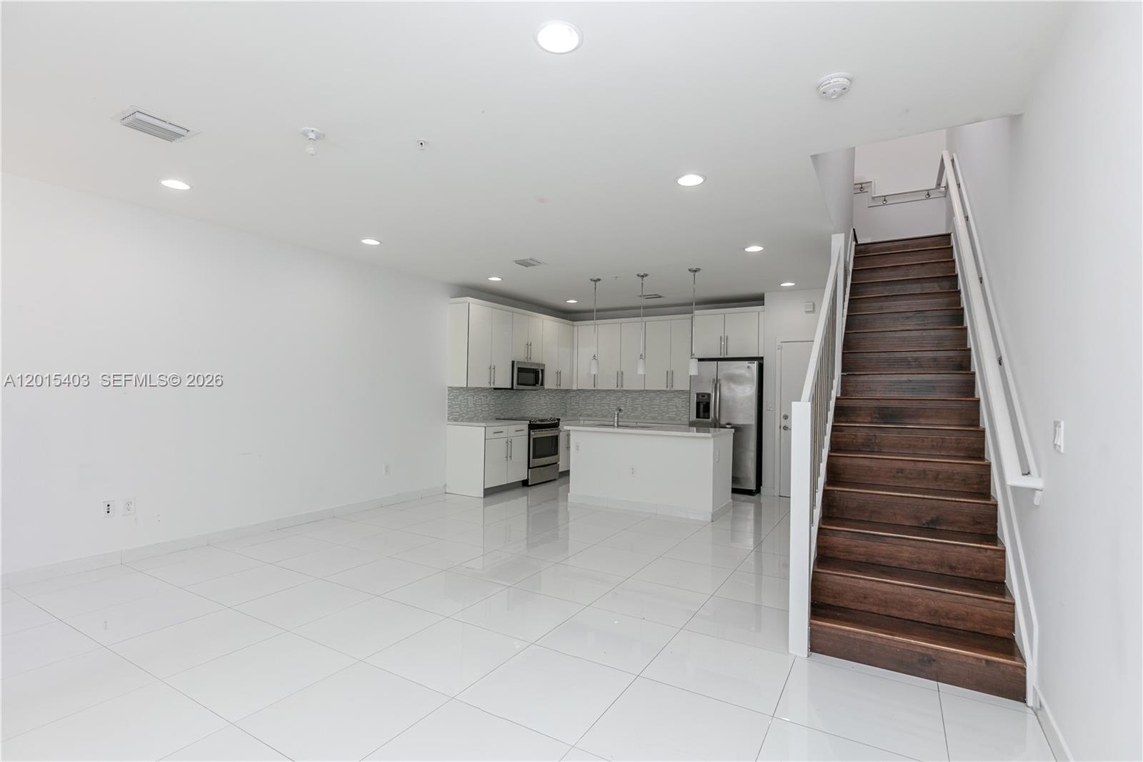 A virtually staged bedroom features a king bed, sliding glass doors, and a private balcony — 2610 NE 213th St # 103, Miami FL 33180, MIAMI, FL