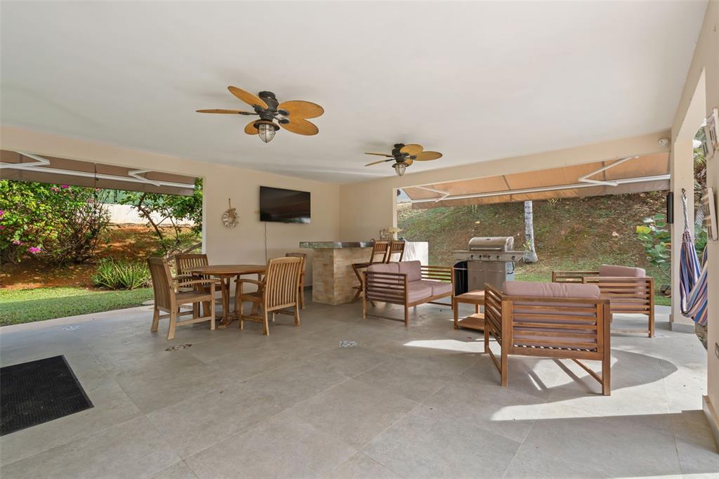 A covered outdoor patio features a dining area, a bar, and lounge seating on tile flooring — 2A Calle del Sol CALLE DEL SOL, FAJARDO, PR