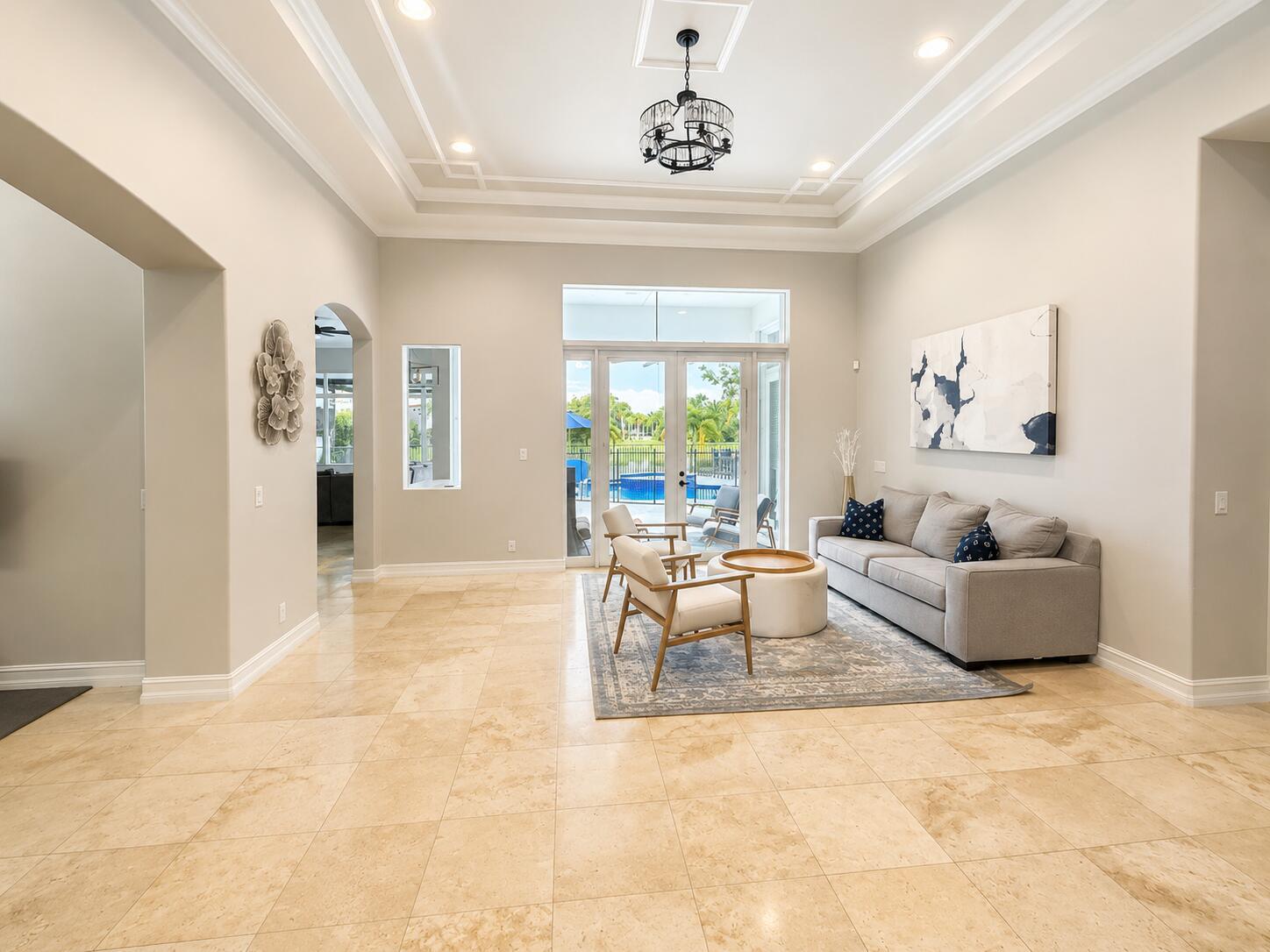 A backyard features a swimming pool, a raised spa, and a covered patio at sunset — 8170 NW 124th Terrace, Parkland FL 33076, PARKLAND, FL