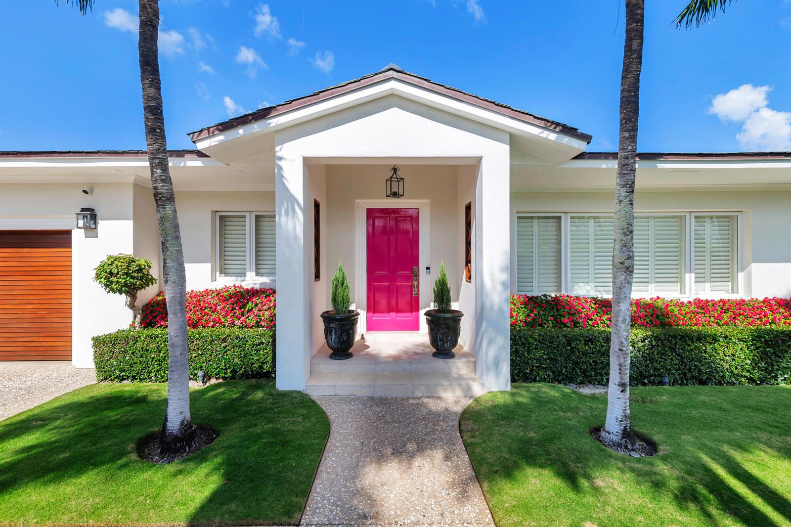 A white house exterior features a bright pink front door and two tall palm trees — 225 Jamaica Lane, Palm Beach FL 33480, PALM BEACH, FL